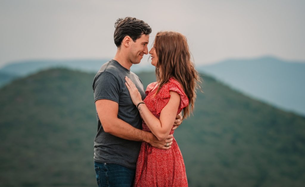 two people staring at each other romatically during black balsam knob engagement photos