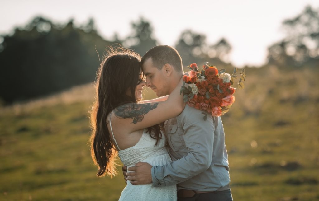 hugging with foreheads together and pretty flowers during a bearwallow mountain elopement