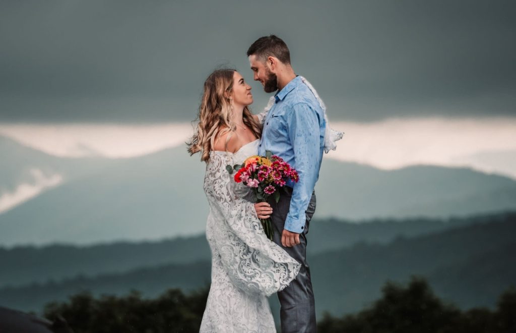 storm clouds roll in behind this couple during their craggy gardens elopement