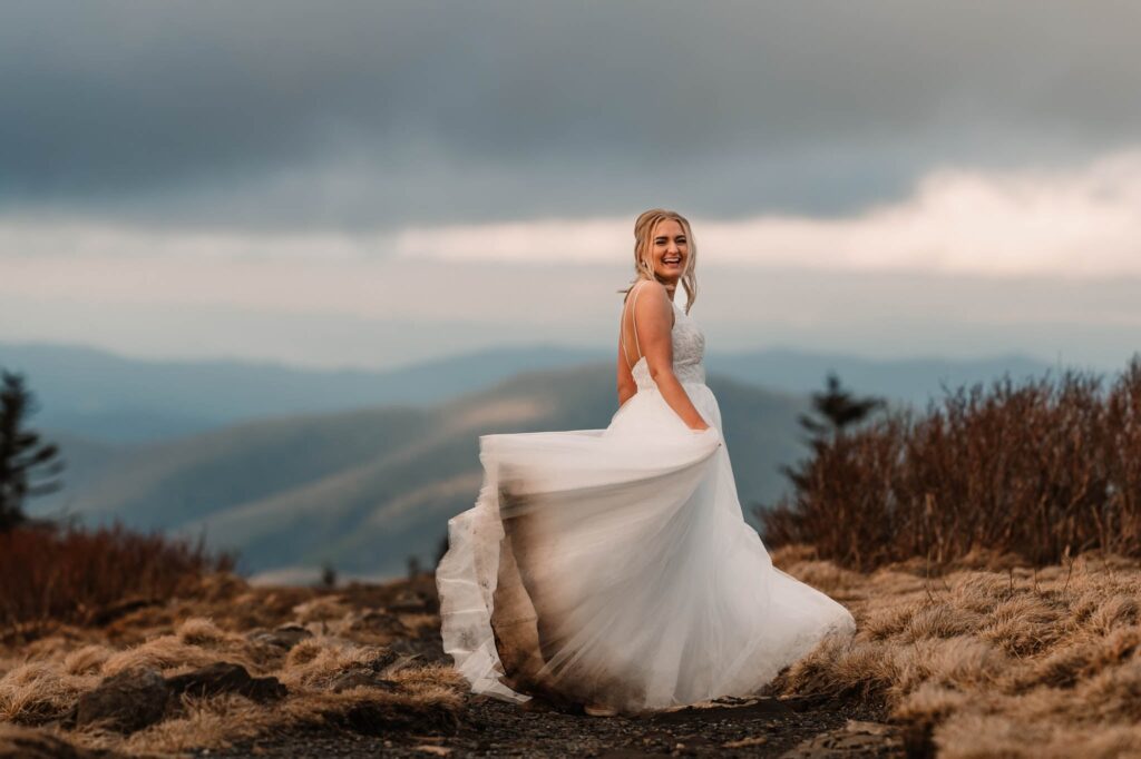 a bride in her dress in the blue ridge mountains
